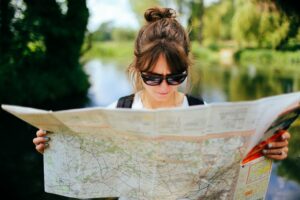 Map. Woman wearing sunglasses and holding map.